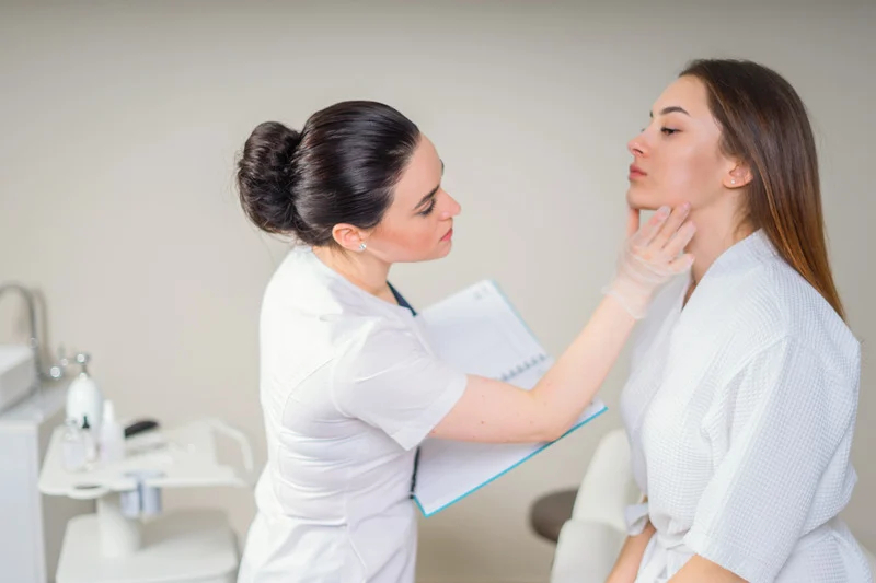 Professional Cosmetician Examining Face Skin of Girl in Clinic of Esthetic Cosmetology